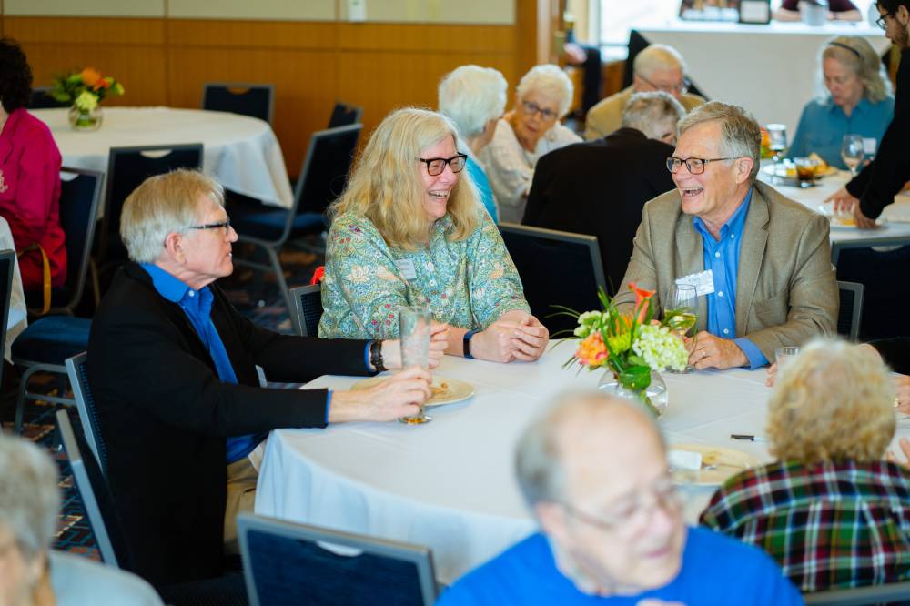 Guests sitting around a table at the Retiree Reception.
